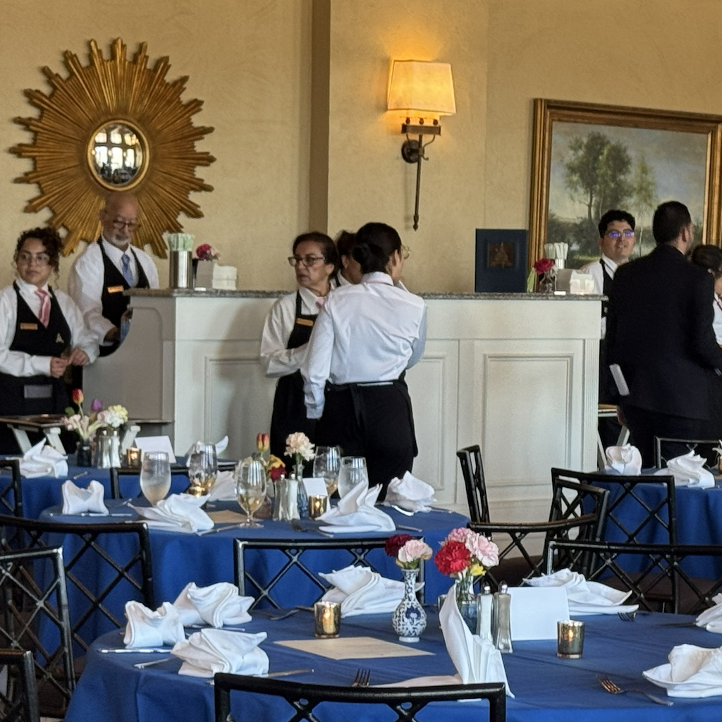 Hospitality staff welcoming guests at a hotel front desk
